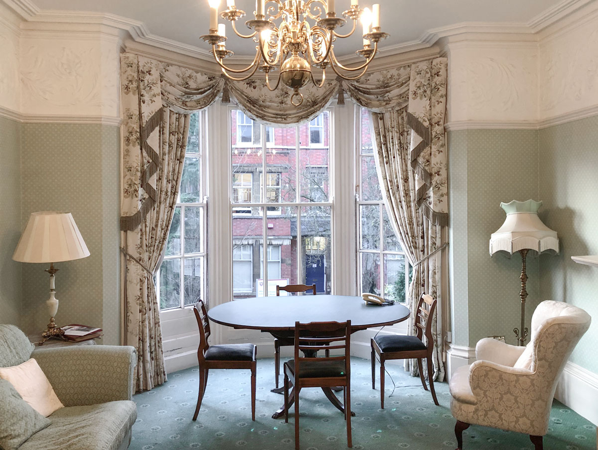 Photograph taken inside the green room on the 1st floor showing the meeting table and front window